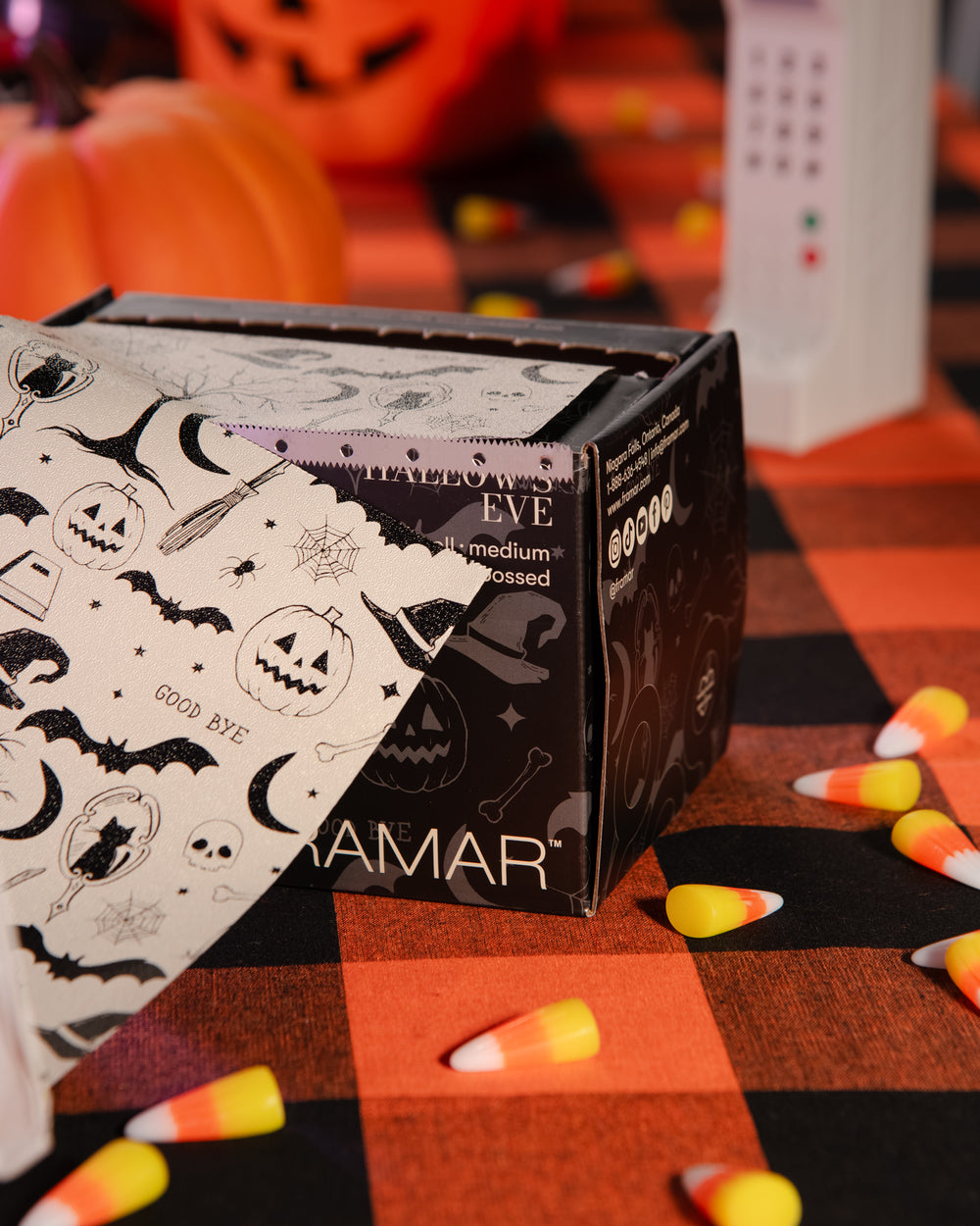 Hallow’s Eve embossed foil roll in its dispensing box, cream foil with black Halloween illustrations